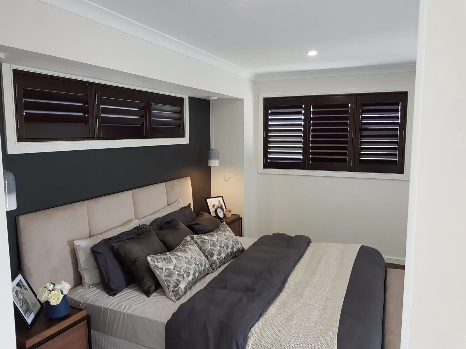 Dark plantation shutters bedroom installation by SupaScreens.
