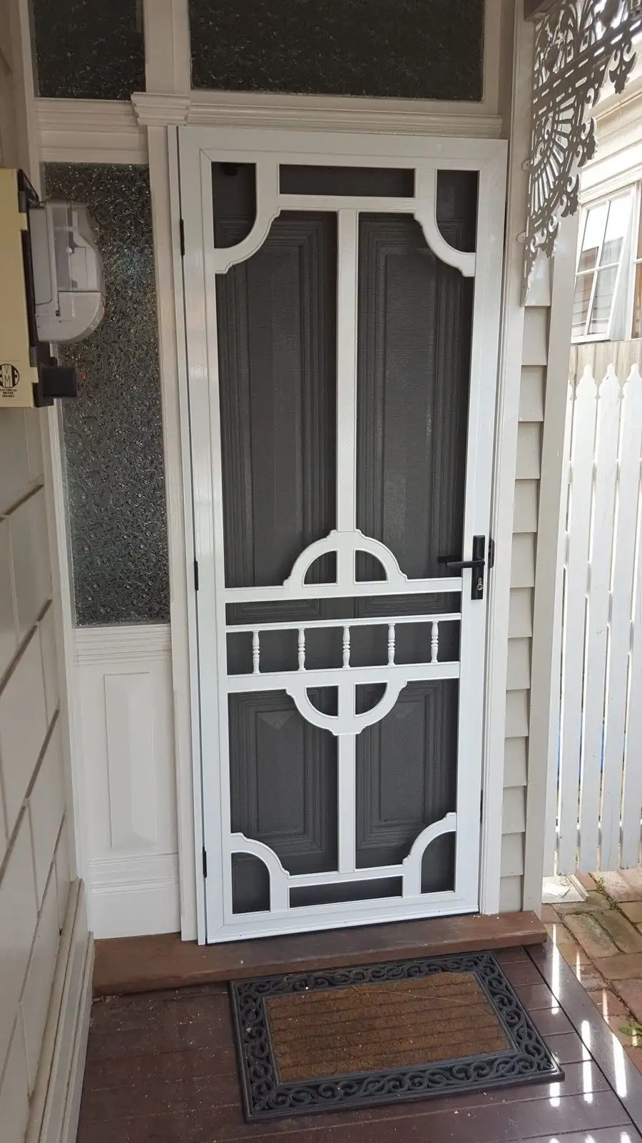 Ornate white security door porch installation by SupaScreens.
