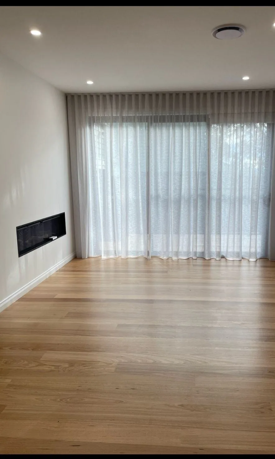 Sheer curtains living room fireplace installation by SupaScreens.