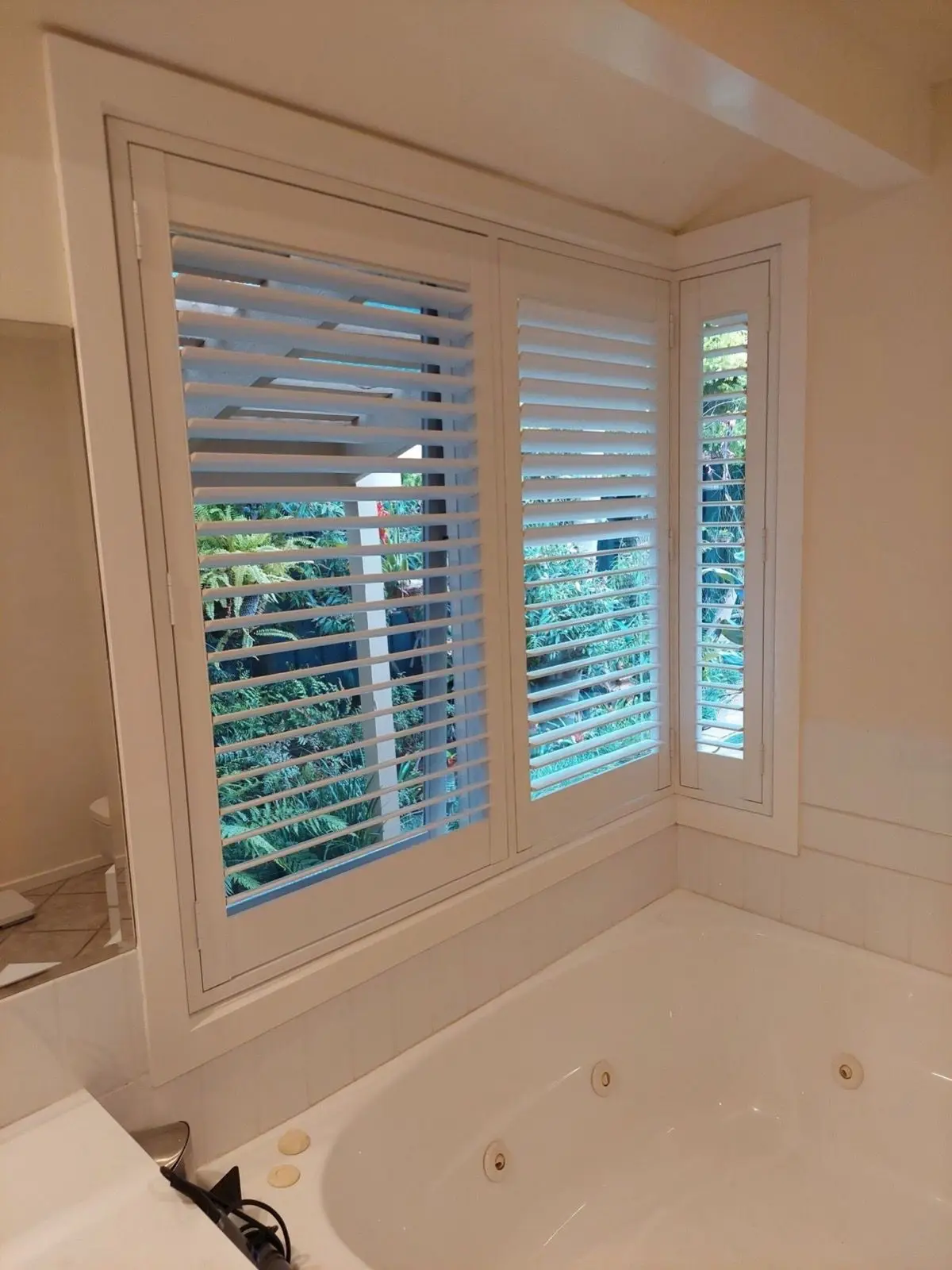 White plantation shutters bathroom installation by SupaScreens.