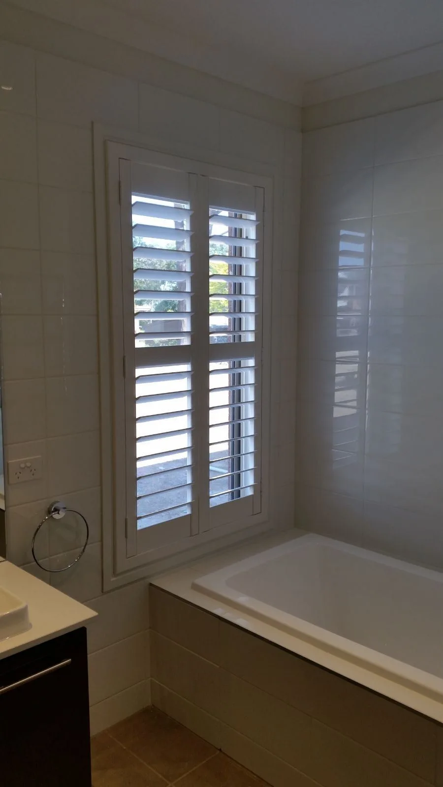 White plantation shutters bathtub installation by SupaScreens.