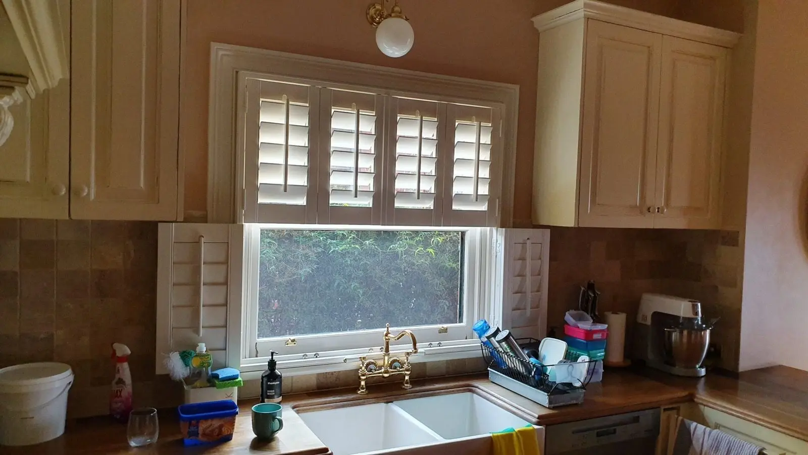 White plantation shutters kitchen sink installation by SupaScreens.