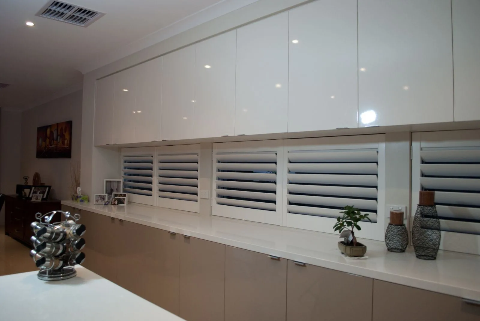 White plantation shutters servery window installation by SupaScreens.