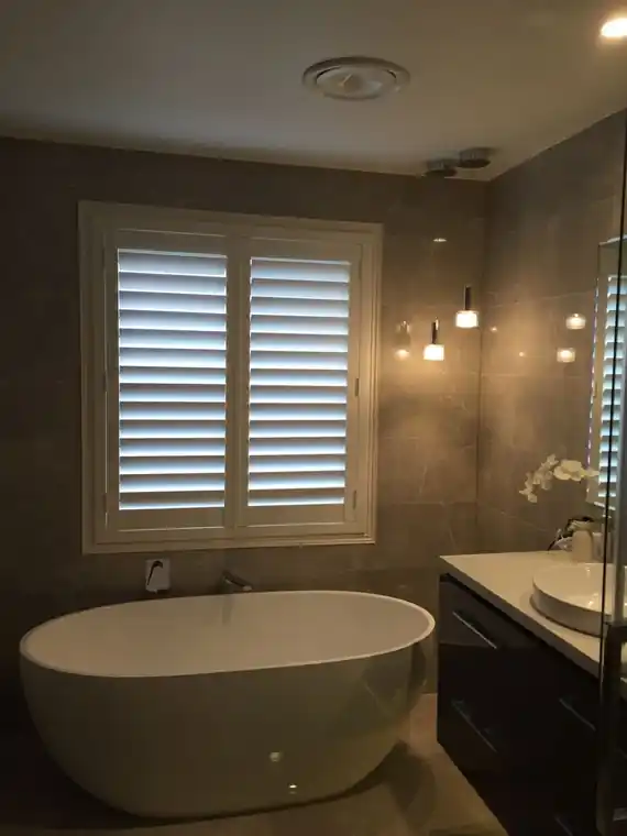 Plantation shutters ensuite window bathtub installation by SupaScreens.